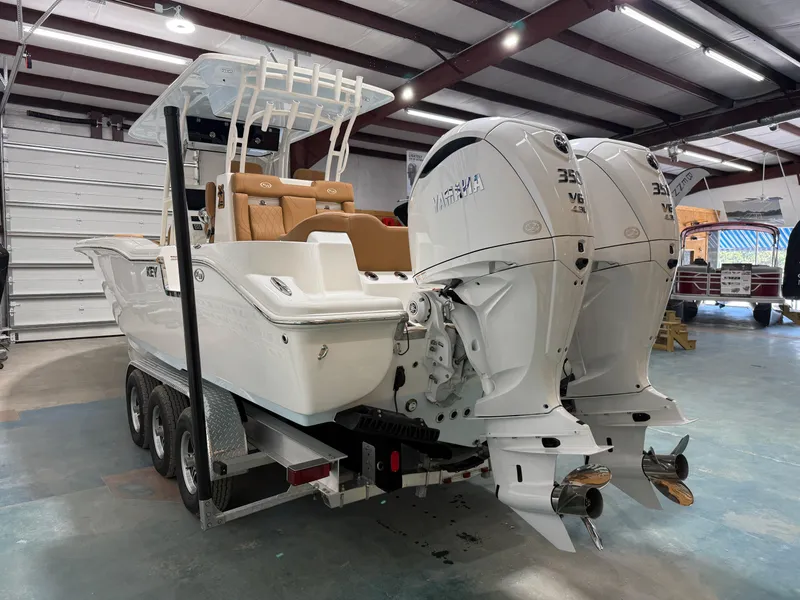 Slide: The Image of 2025 Key West 291FS boat with dual Yamaha engines in a garage setting. - 6