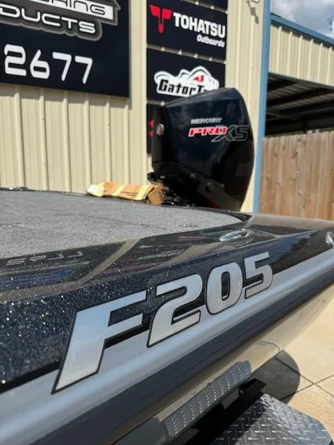 Slide: The Image of 2025 Falcon F205 boat with Mercury Pro XS engine, outdoor showroom display. - 2