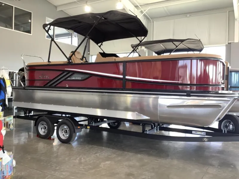 The Image of 2025 G3 Fusion 322RC pontoon boat with red exterior on a trailer in showroom. - 1