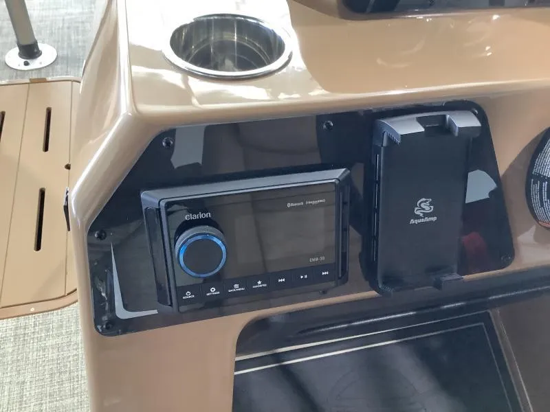 Slide: The Image of 2025 G3 Fusion 322RC boat dashboard with Clarion audio system and cup holder. - 13