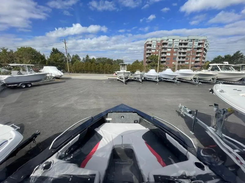 Slide: The Image of 2024 Princecraft AYB5258TS boat in a marina with other boats, under a blue sky. - 10