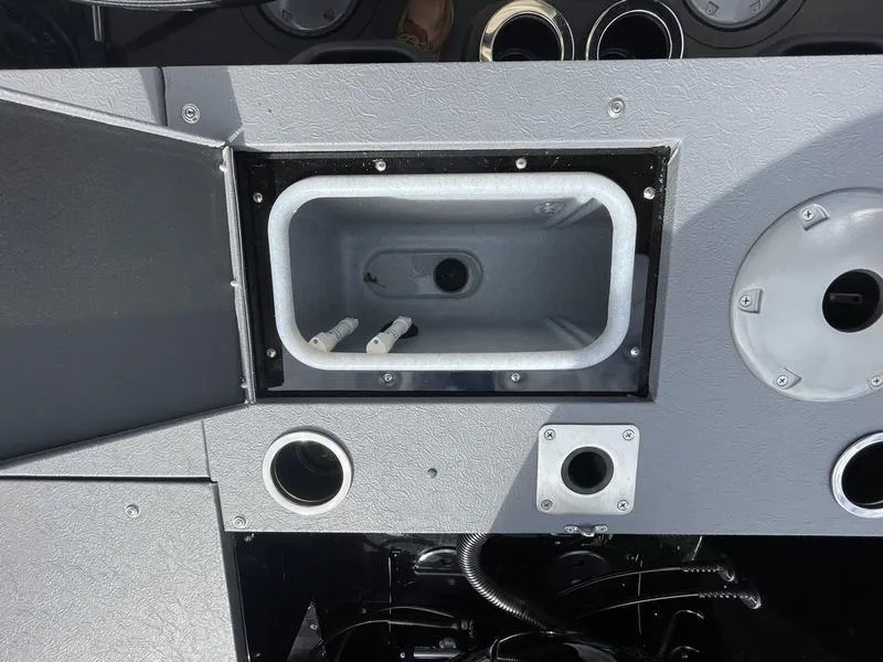 Slide: The Image of 2024 Princecraft AYB5258TS boat dashboard with storage compartment and control panel. - 12