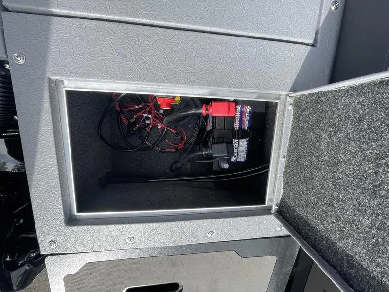 Slide: The Image of 2024 Princecraft AYB5258TS boat storage compartment with wiring and battery. - 14