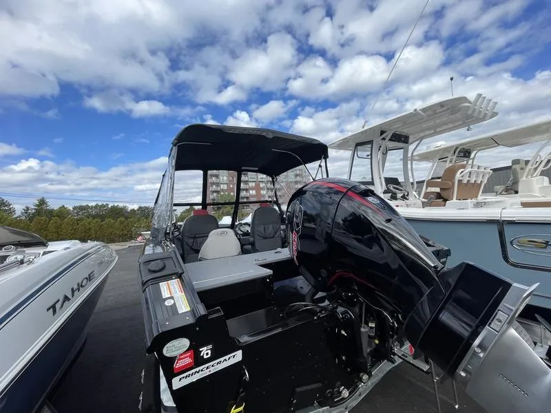 Slide: The Image of 2024 Princecraft AYB5258TS boat with powerful outboard motor, docked under a cloudy sky. - 3