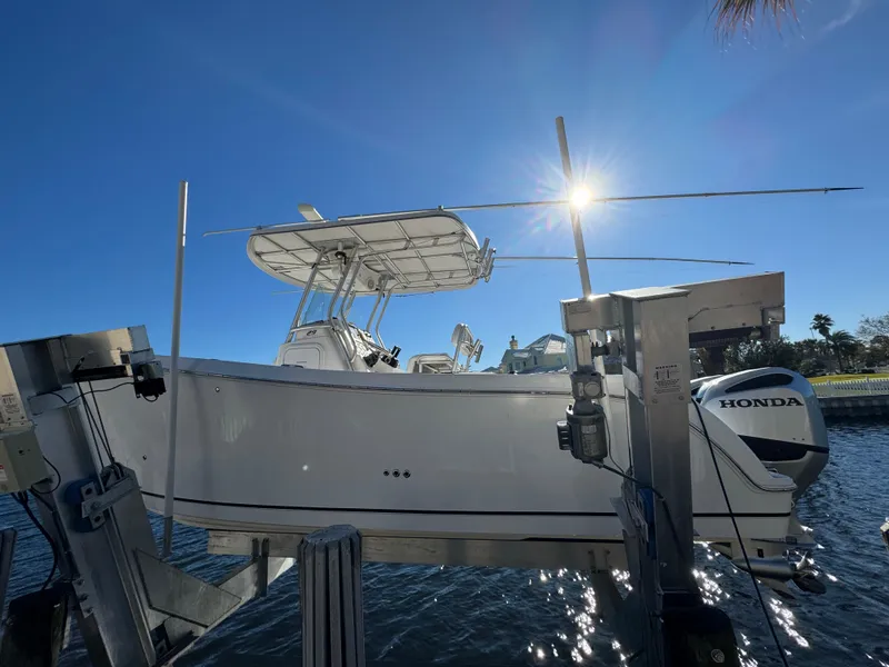 Slide: The Image of 2007 Pro-Line 29 Super Sport boat on lift with Honda outboard motor. - 1