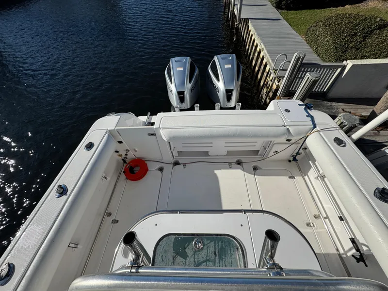Slide: The Image of 2007 Pro-Line 29 Super Sport boat with dual engines docked by the water. - 17