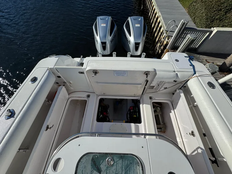 Slide: The Image of 2007 Pro-Line 29 Super Sport boat with dual outboard engines docked. - 18