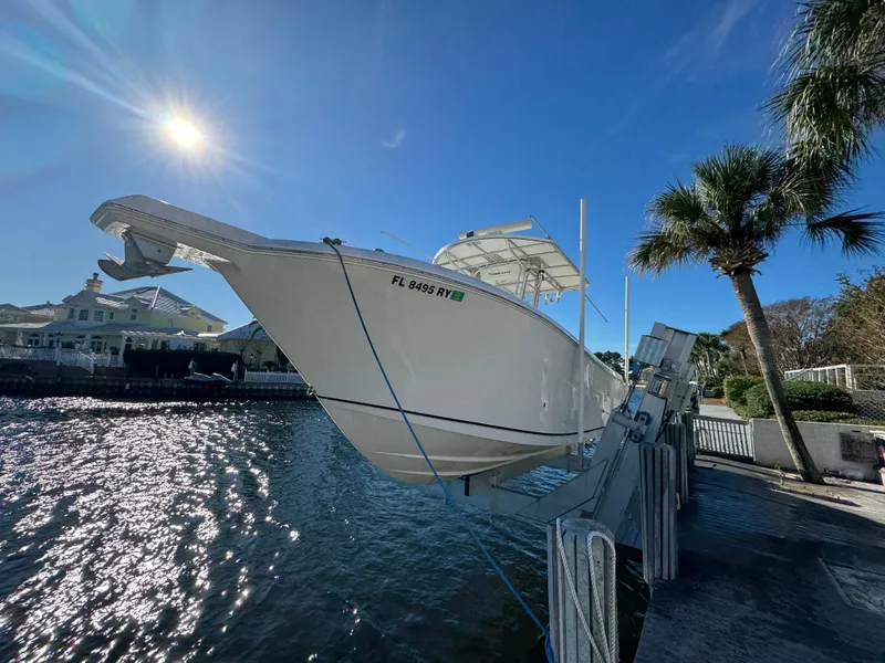 Slide: The Image of 2007 Pro-Line 29 Super Sport boat docked by waterfront under clear blue sky. - 2