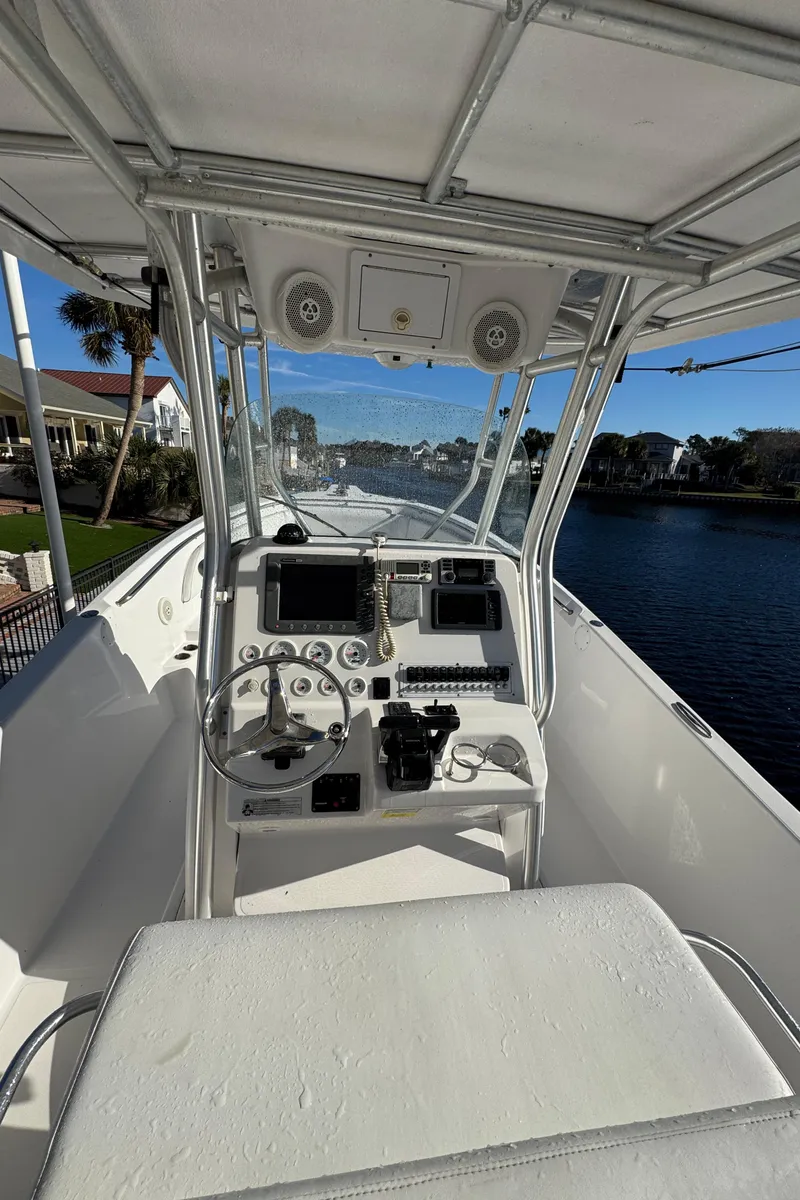 Slide: The Image of 2007 Pro-Line 29 Super Sport boat cockpit with navigation controls and seating. - 25