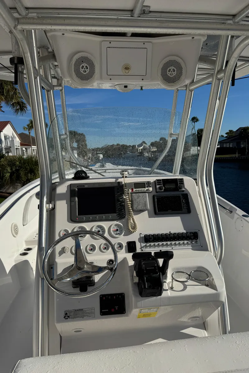 Slide: The Image of 2007 Pro-Line 29 Super Sport boat dashboard with steering wheel and controls. - 27