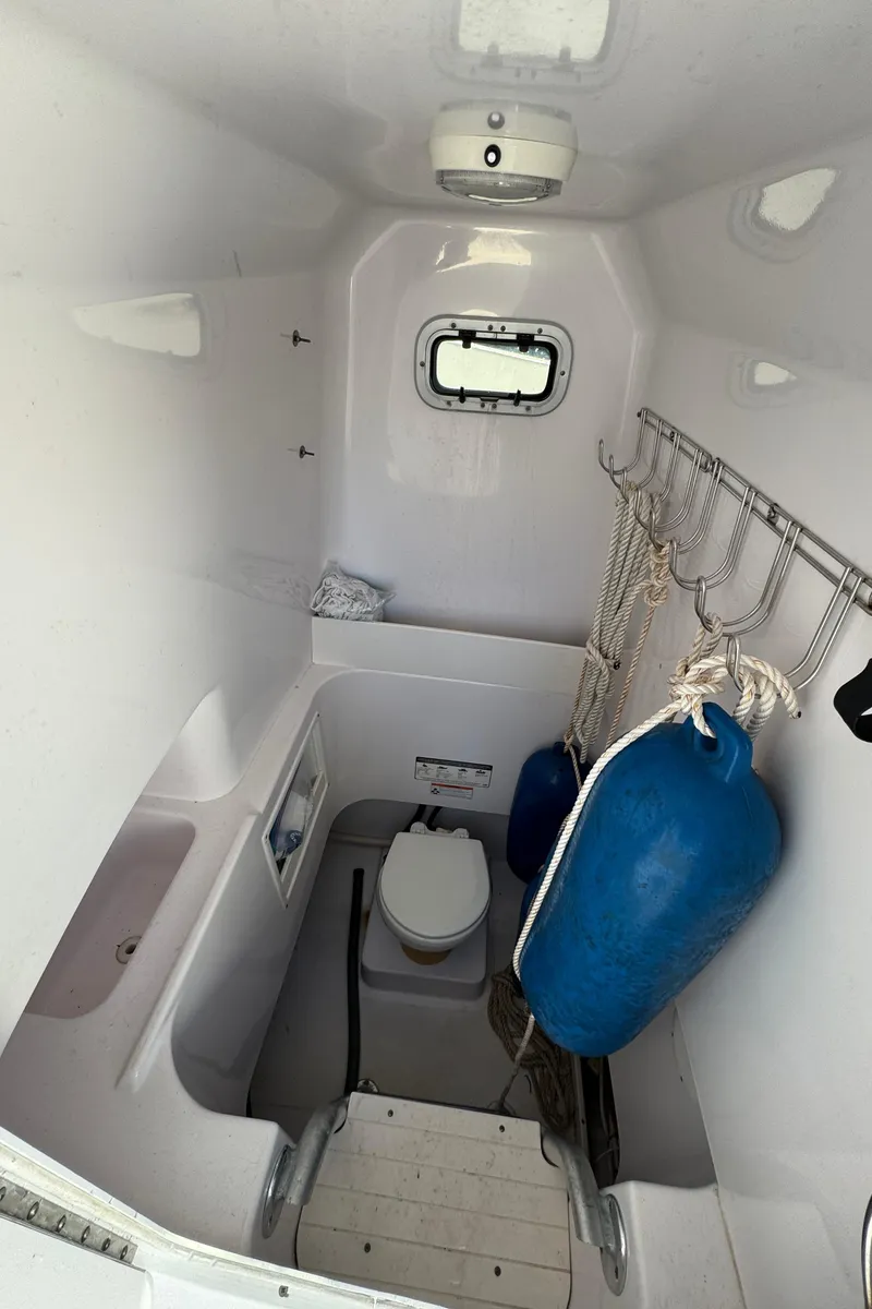 Slide: The Image of 2007 Pro-Line 29 Super Sport boat interior with toilet and storage area. - 29