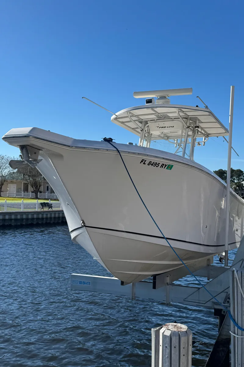 Slide: The Image of 2007 Pro-Line 29 Super Sport boat docked by the water. - 3