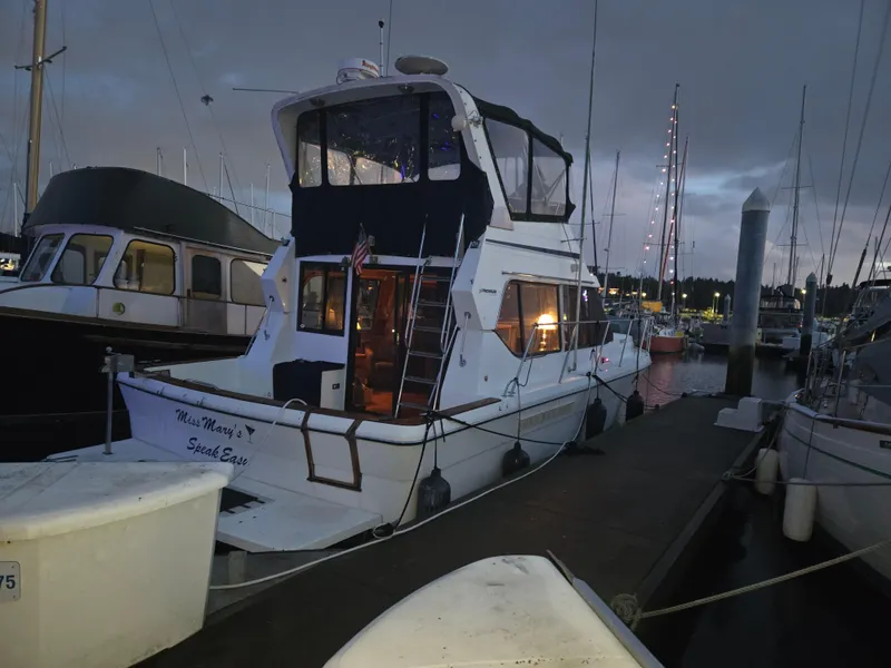 Slide: The Image of 1991 Cooper Prowler boat docked at marina during evening. - 0