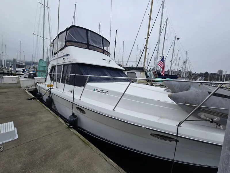 Slide: The Image of 1991 Cooper Prowler boat docked at marina with American flag. - 1