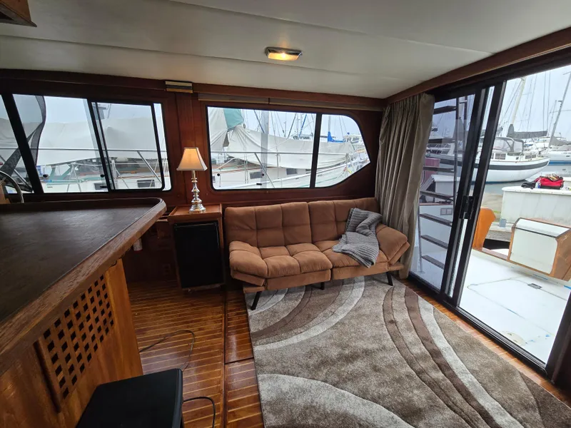 Slide: The Image of Cozy interior of 1991 Cooper Prowler yacht with sofa, lamp, and marina view. - 10