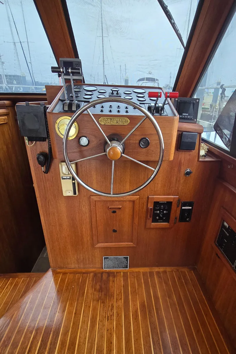 Slide: The Image of 1991 Cooper Prowler boat helm with wooden steering wheel and control panel. - 11
