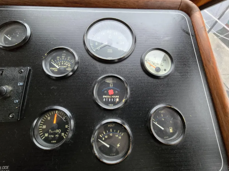 Slide: The Image of Dashboard gauges of a 1991 Cooper Prowler boat, showing engine hours and various indicators. - 14