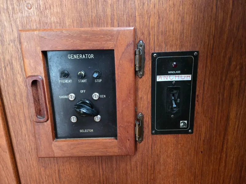 Slide: The Image of Wooden panel with generator controls on a 1991 Cooper Prowler boat. - 16