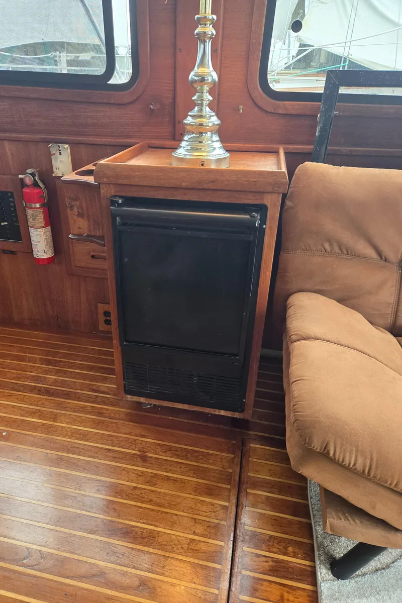 Slide: The Image of Interior of a 1991 Cooper Prowler with wood flooring and a small fridge. - 17