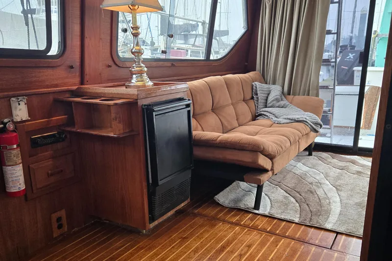 Slide: The Image of Cozy 1991 Cooper Prowler yacht interior with sofa, lamp, and wooden flooring. - 18