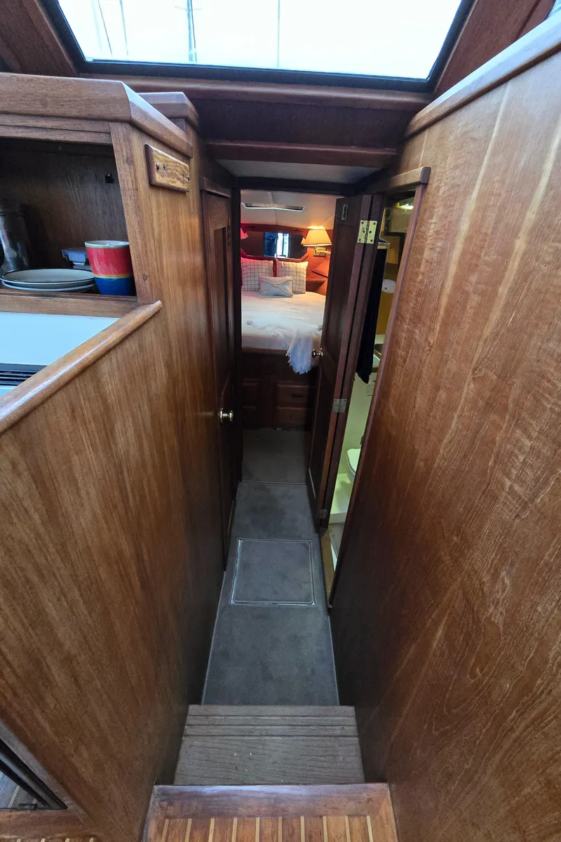 Slide: The Image of Interior view of 1991 Cooper Prowler boat with wooden paneling and narrow hallway. - 20