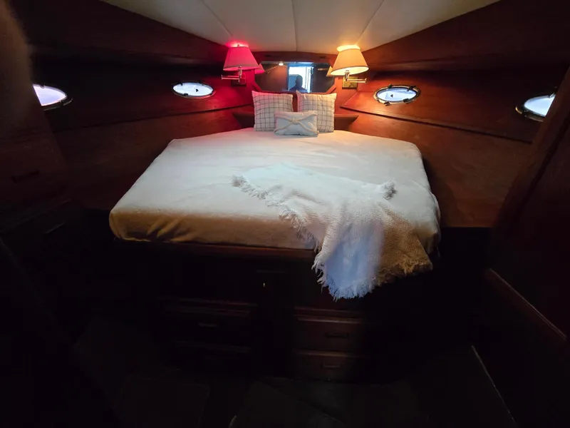 Slide: The Image of Cozy cabin interior of 1991 Cooper Prowler with bed and ambient lighting. - 24