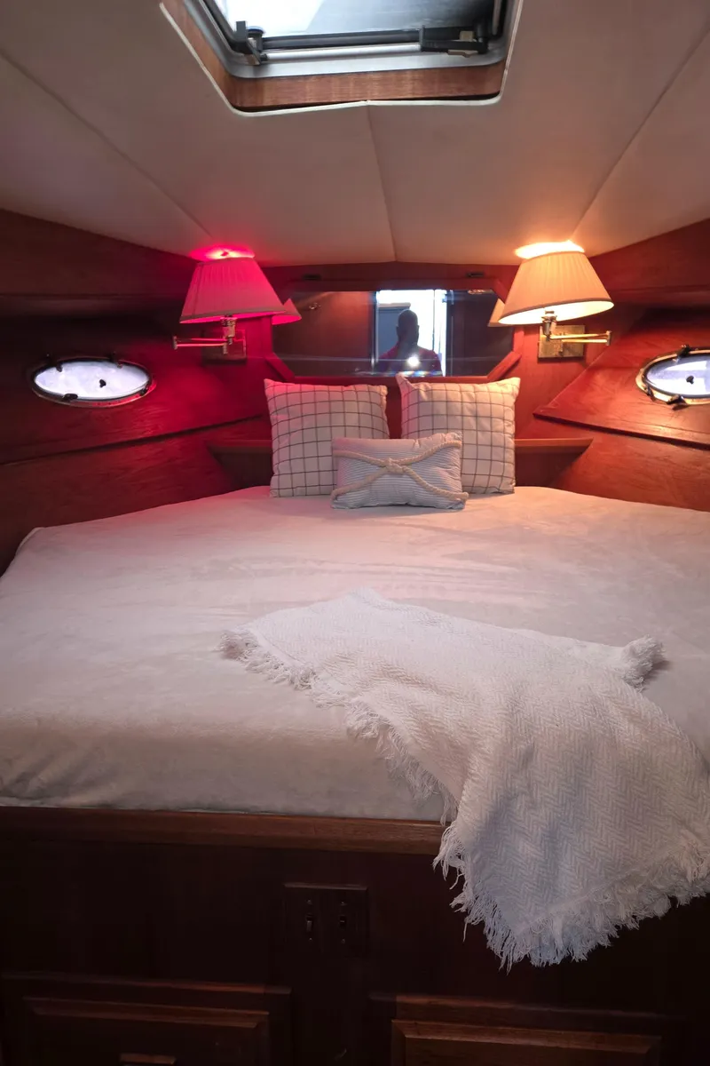Slide: The Image of Cozy bedroom in 1991 Cooper Prowler boat with soft lighting and plush bedding. - 25