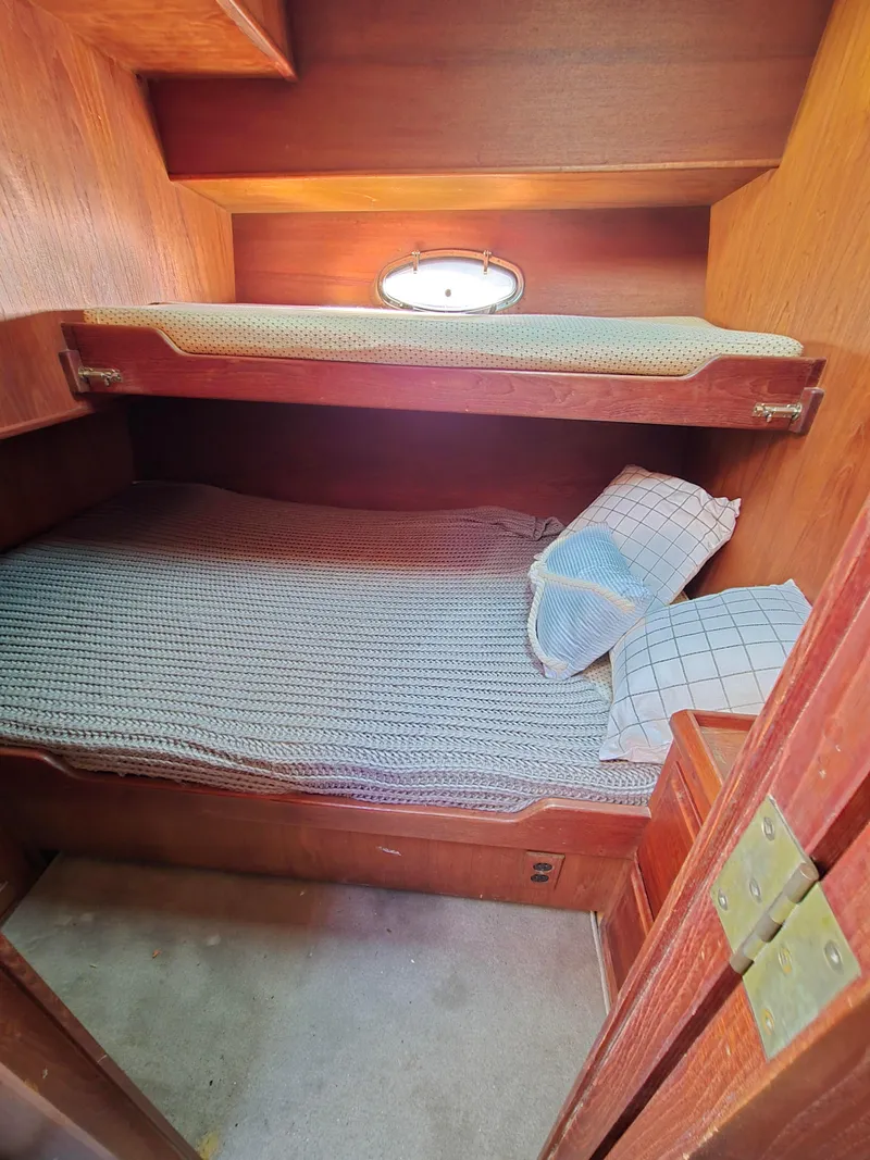 Slide: The Image of 1991 Cooper Prowler cabin interior with wooden bunk beds and a small window. - 27