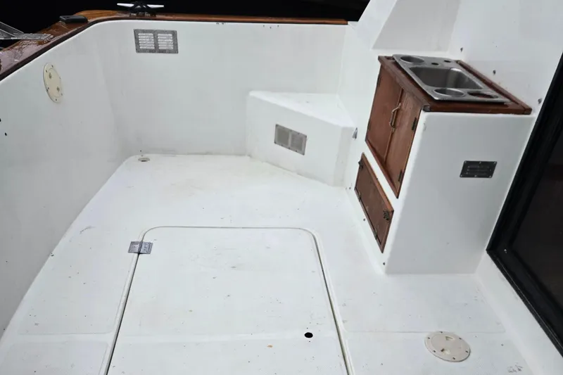 Slide: The Image of 1991 Cooper Prowler boat deck with sink and storage cabinets. - 3