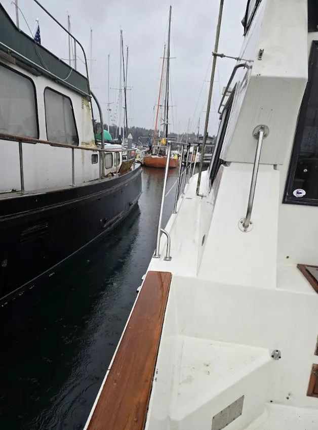 Slide: The Image of 1991 Cooper Prowler boat docked alongside other vessels in a marina. - 4