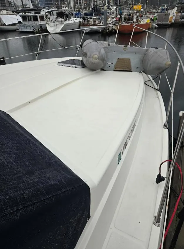 Slide: The Image of 1991 Cooper Prowler boat docked at marina with inflatable fenders. - 5