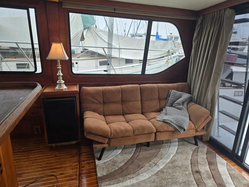 Slide: The Image of Cozy 1991 Cooper Prowler yacht interior with sofa, lamp, and marina view. - 9
