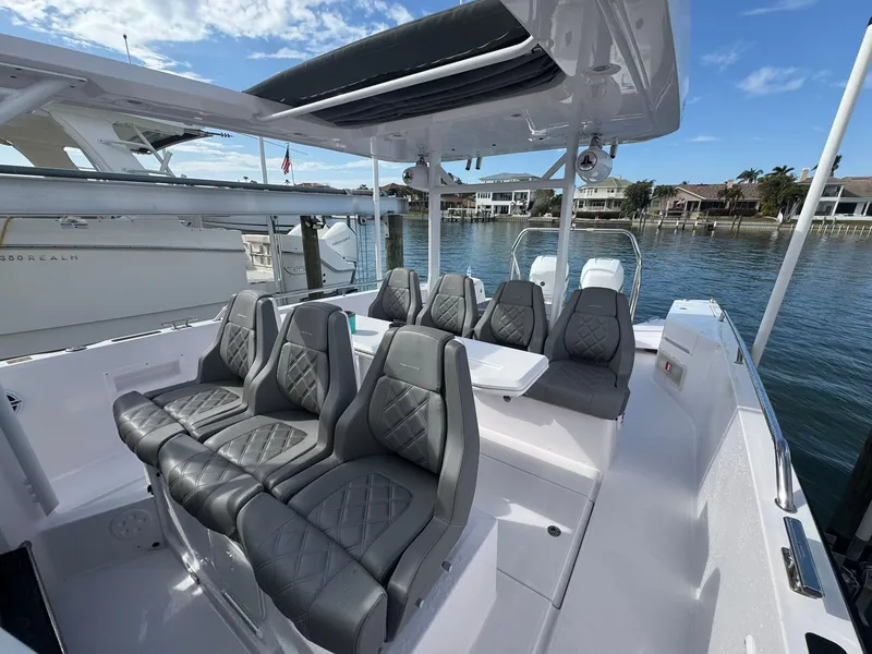 Slide: The Image of 2021 Axopar 37ST boat with luxurious seating, docked by waterfront homes. - 14