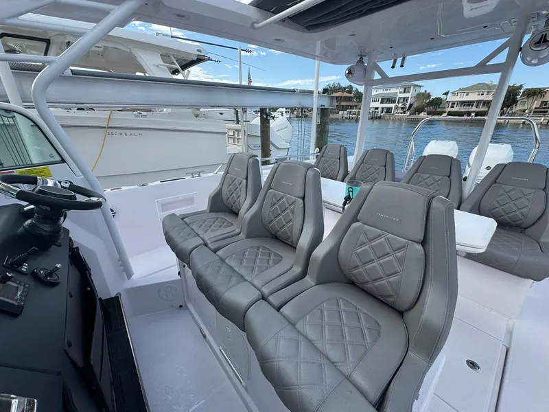 Slide: The Image of 2021 Axopar 37ST boat with luxurious gray seating and waterfront view. - 15