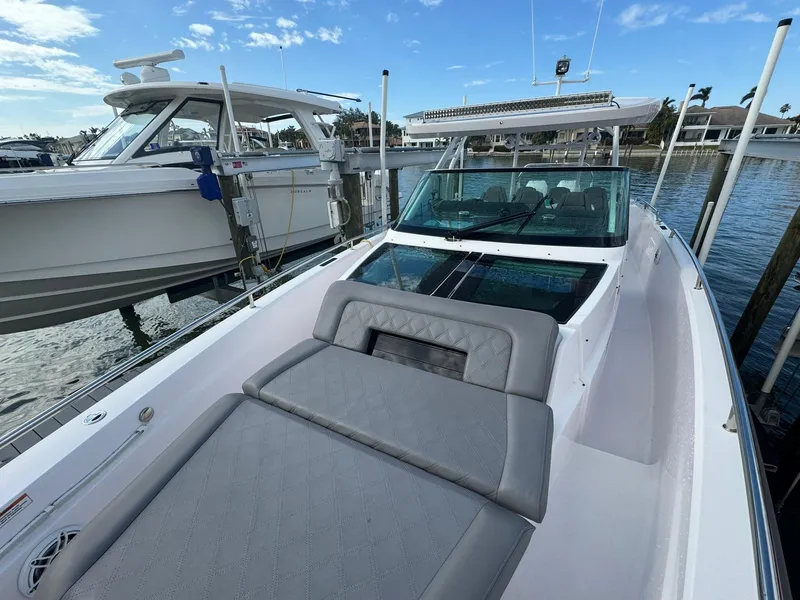 Slide: The Image of 2021 Axopar 37ST boat with sleek design and comfortable seating, docked by the water. - 20