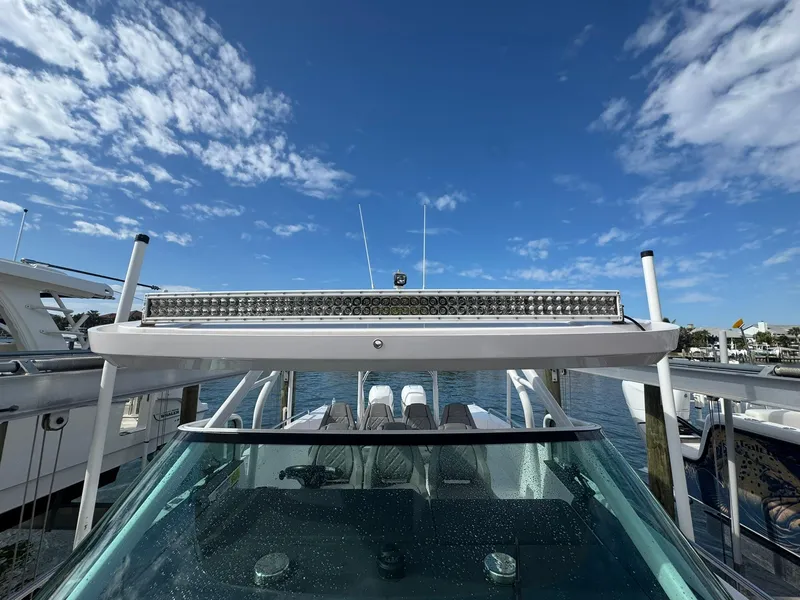 Slide: The Image of 2021 Axopar 37ST boat with clear sky and marina background. - 24