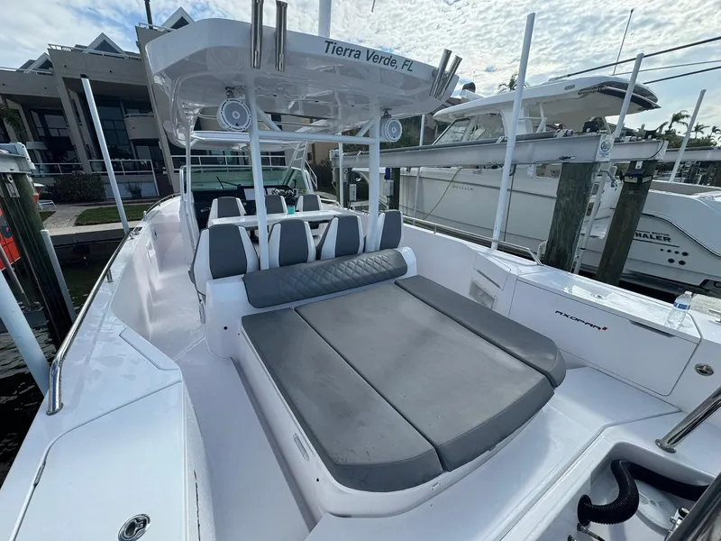 Slide: The Image of 2021 Axopar 37ST boat with spacious seating, docked in marina, under partly cloudy sky. - 26