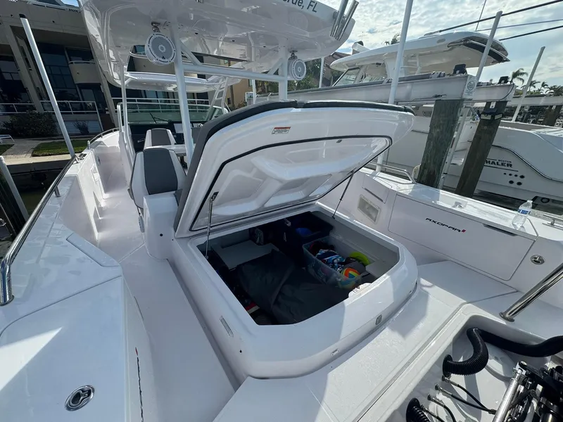 Slide: The Image of 2021 Axopar 37ST boat with open storage compartment at marina. - 27