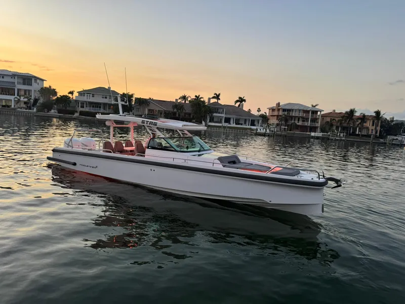 Slide: The Image of 2021 Axopar 37ST boat on calm water at sunset near waterfront homes. - 3