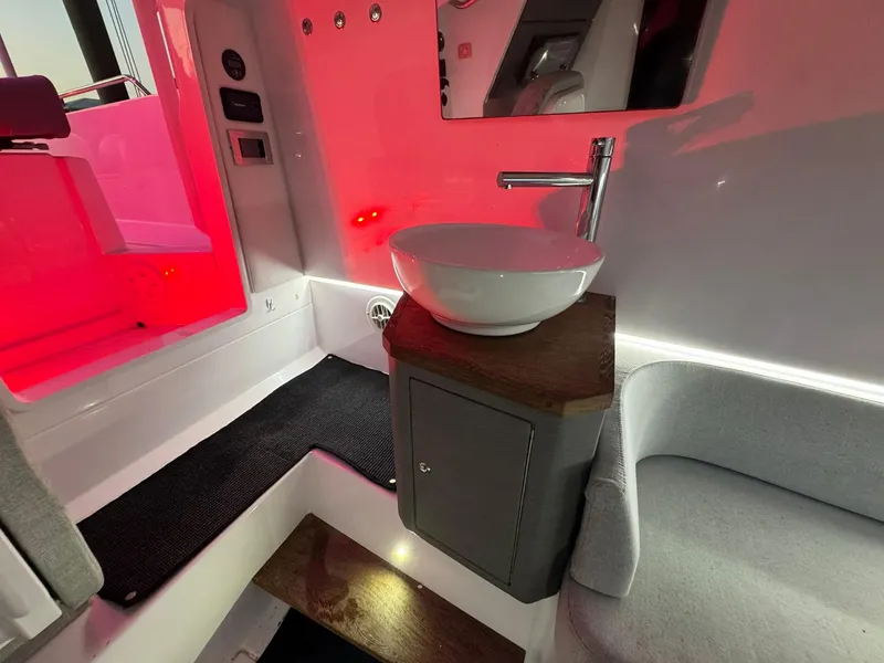 Slide: The Image of 2021 Axopar 37ST interior with modern sink and ambient red lighting. - 33