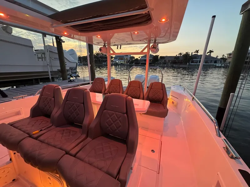 Slide: The Image of 2021 Axopar 37ST boat interior with luxurious seating at sunset. - 36
