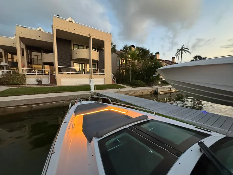 Slide: The Image of Axopar 37ST 2021 docked near modern waterfront homes at sunset. - 40