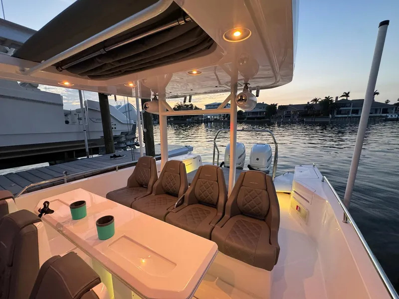 Slide: The Image of Luxurious 2021 Axopar 37ST boat interior at sunset, featuring comfortable seating and elegant design. - 41