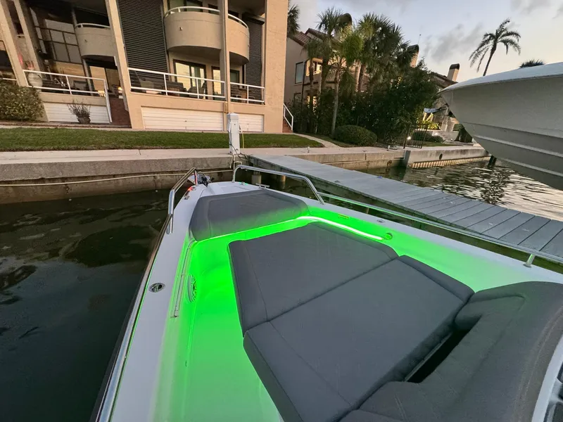 Slide: The Image of Axopar 37ST 2021 boat with green LED lights docked near waterfront homes. - 44