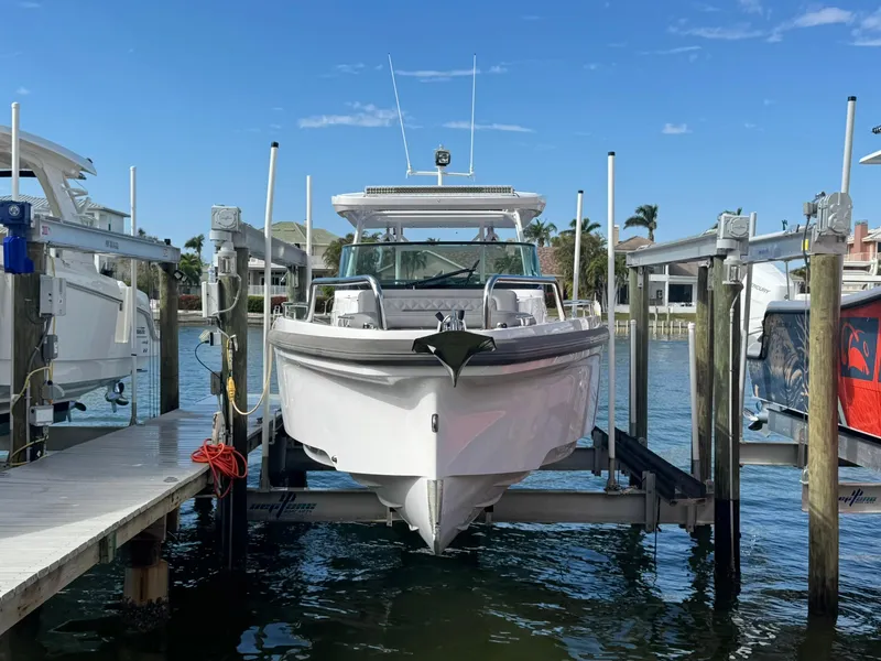 Slide: The Image of 2021 Axopar 37ST boat docked at marina, clear sky background. - 5