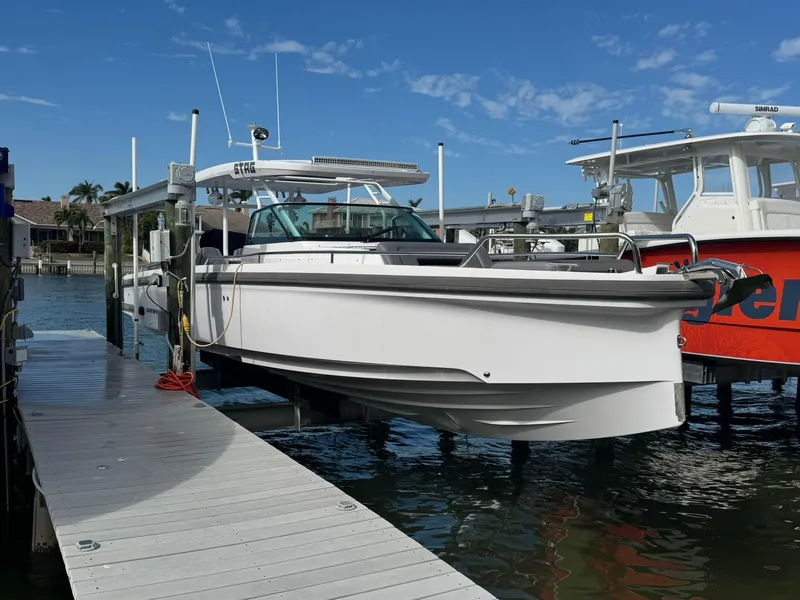 Slide: The Image of 2021 Axopar 37ST boat docked at marina under clear blue sky. - 6