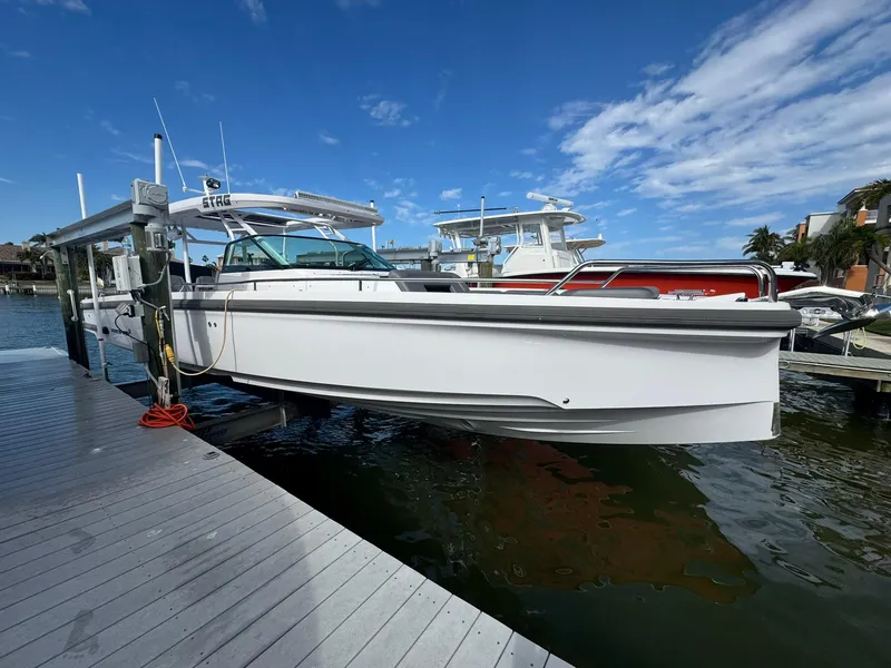 Slide: The Image of 2021 Axopar 37ST boat docked on a sunny day with clear skies. - 7