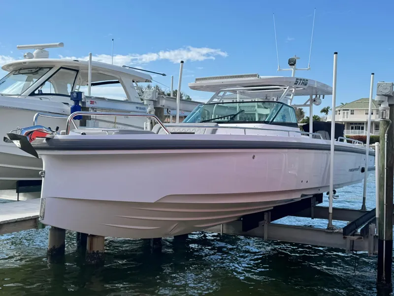 Slide: The Image of 2021 Axopar 37ST boat docked on water, side view. - 8