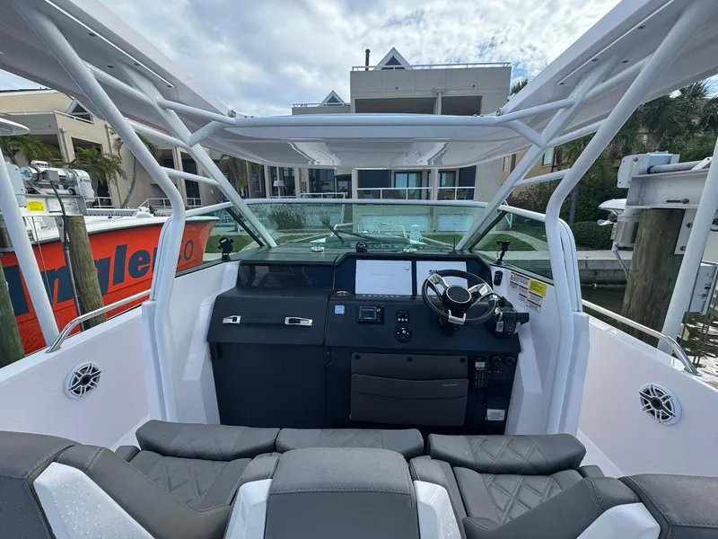 Slide: The Image of 2021 Axopar 37ST boat cockpit with modern controls and seating. - 9