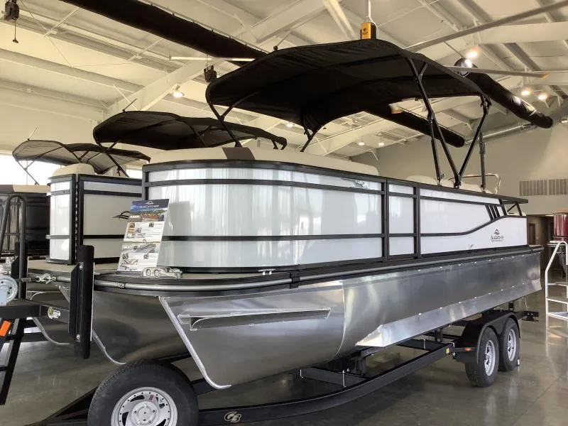 The Image of 2025 G3 SELECT 324SS pontoon boat in showroom, featuring sleek design and dual canopy. - 1